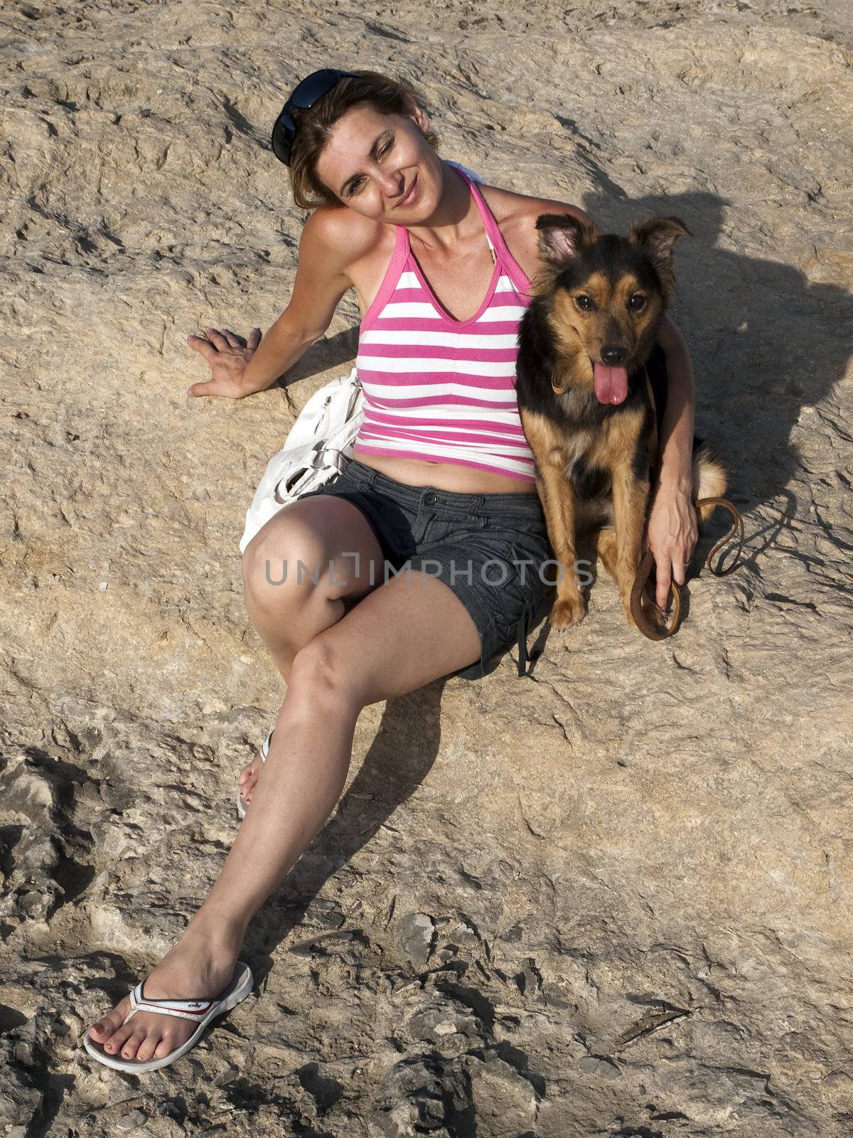 Woman with dog at the seaside in a tropical country