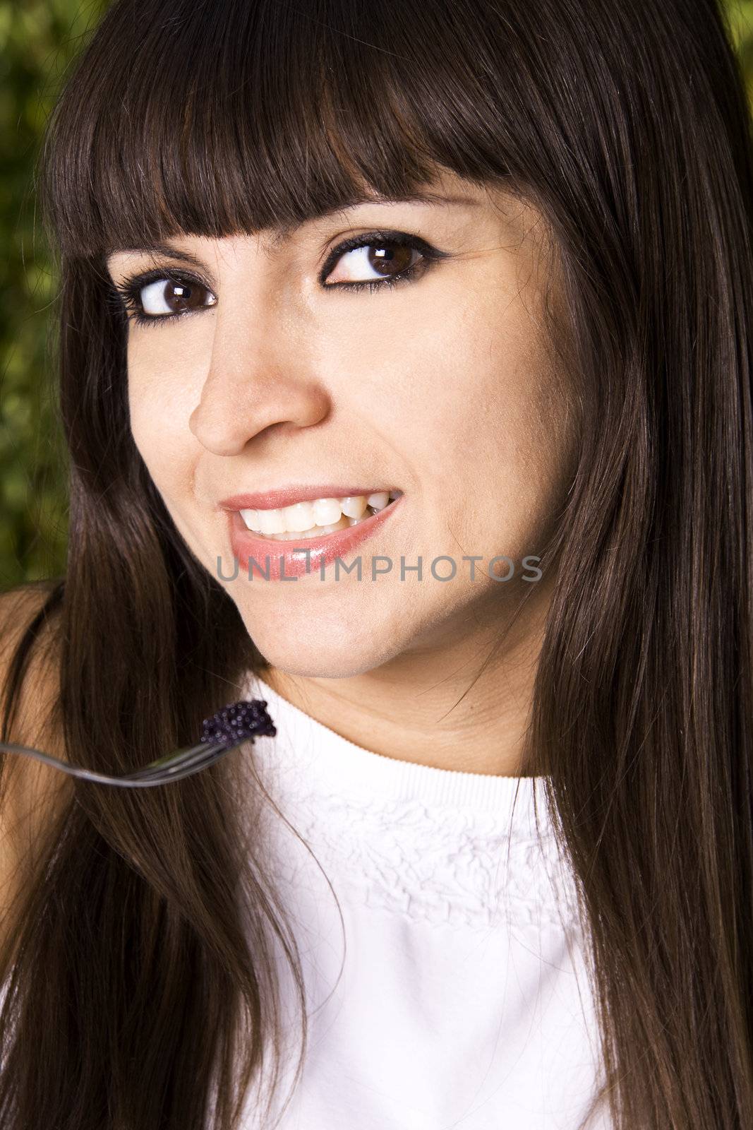 Beautiful Brazilian woman eating black caviar with a small fork