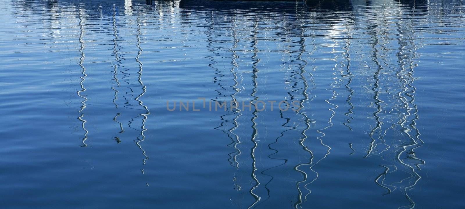 Boats abstract reflexion over blue mediterranean saltwater