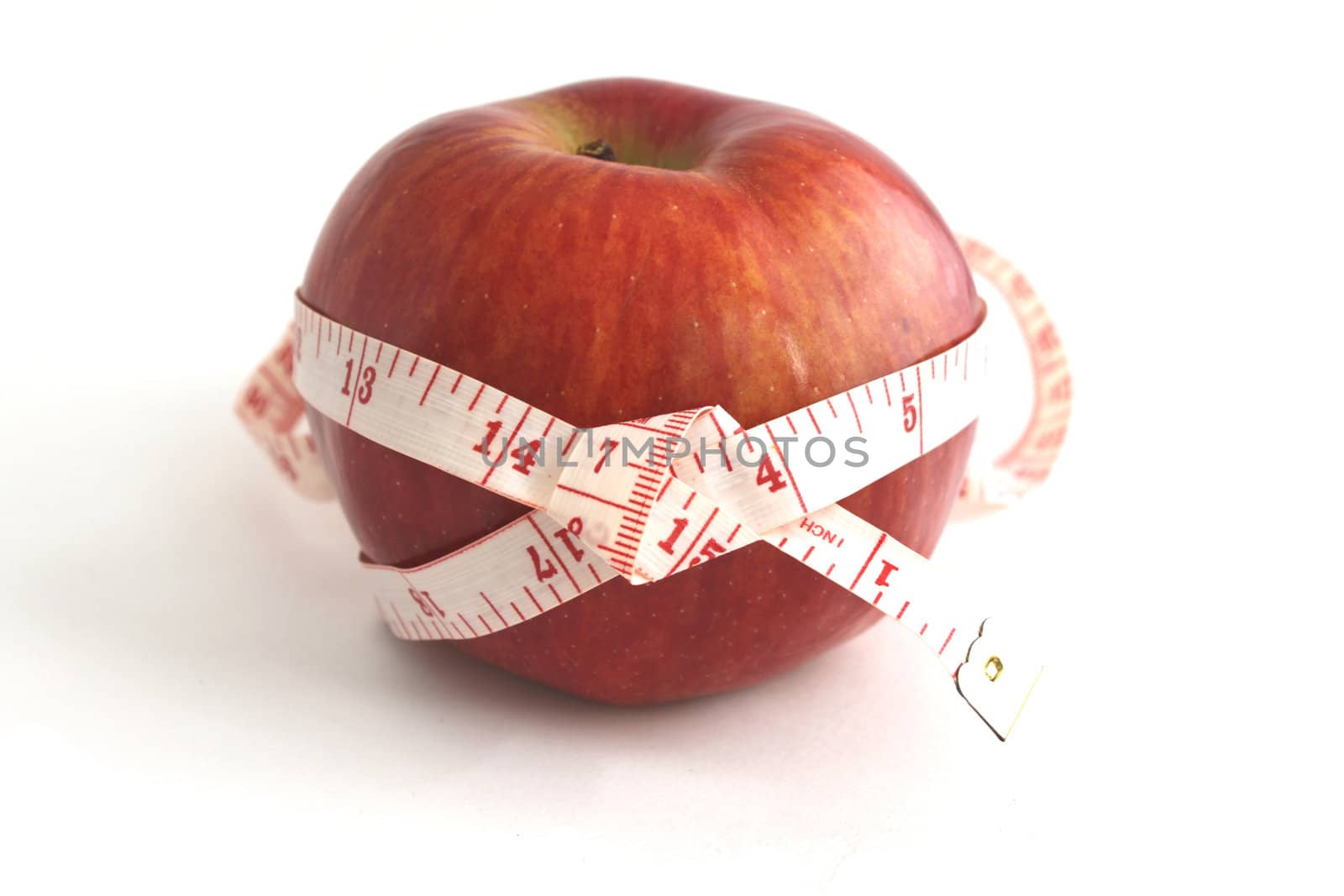 Apple and measuring tape isolated on white