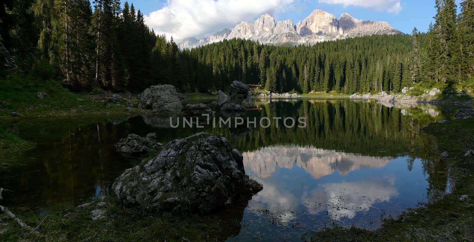Reflection of the Dolomites in Italy in the quiet Carezza Lake