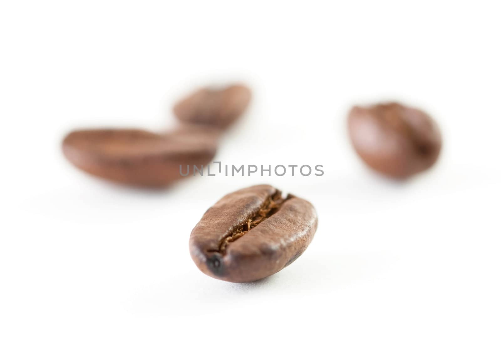A close up shoot of some coffee beans isolated on white background