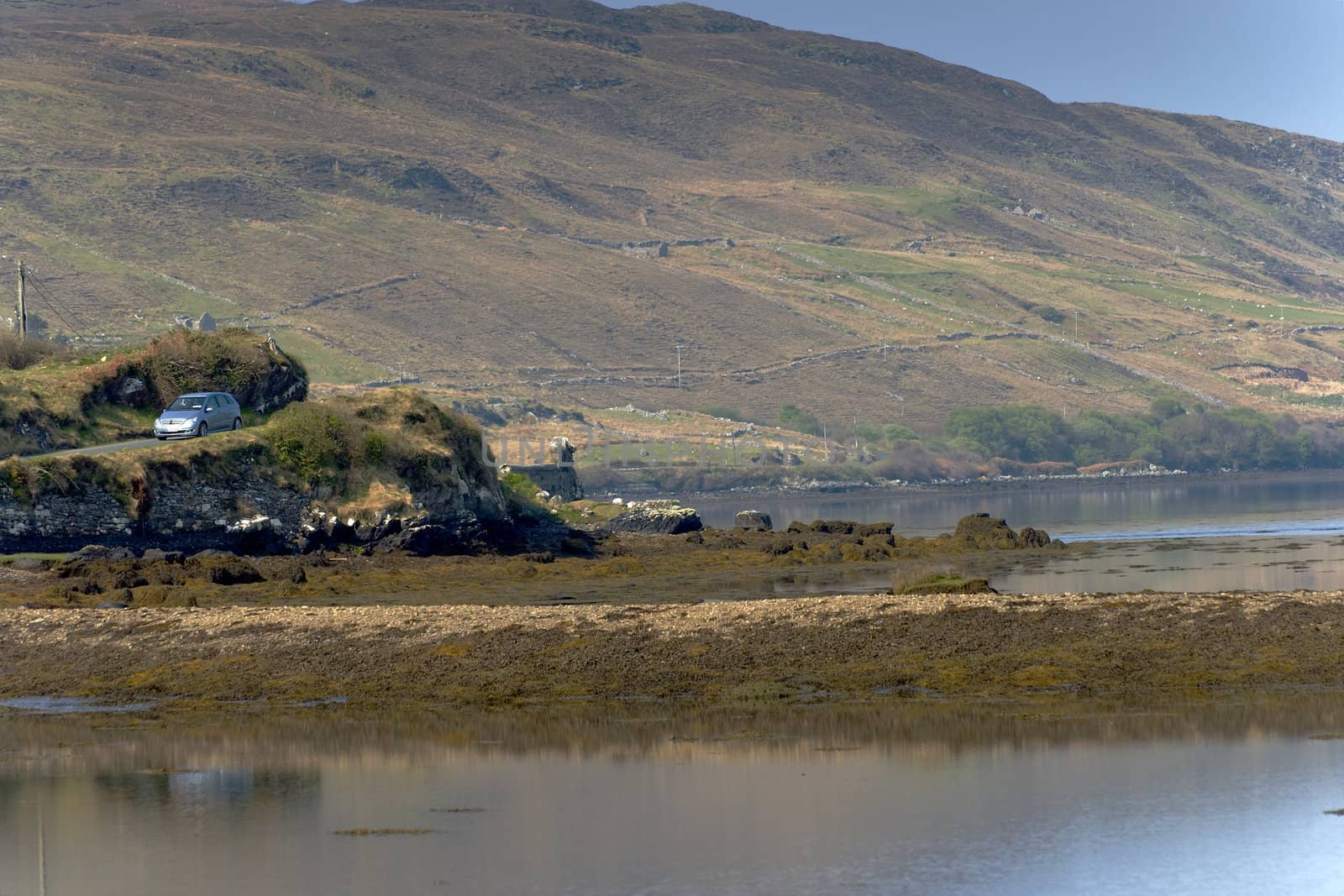 Car travelling though lakside road at Connemara, Ireland