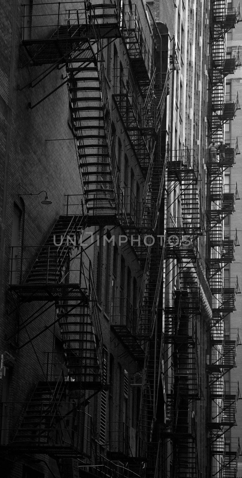 Chicago fire escape ladders in a dark alley in black and white