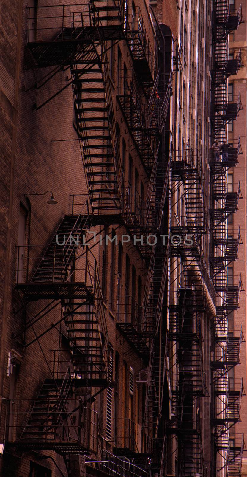 Chicago fire escape ladders in a dark alley