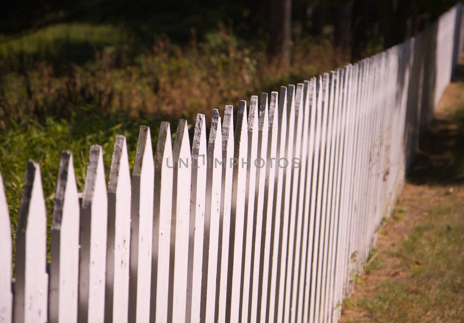 residential white picket fence diminishing in distance