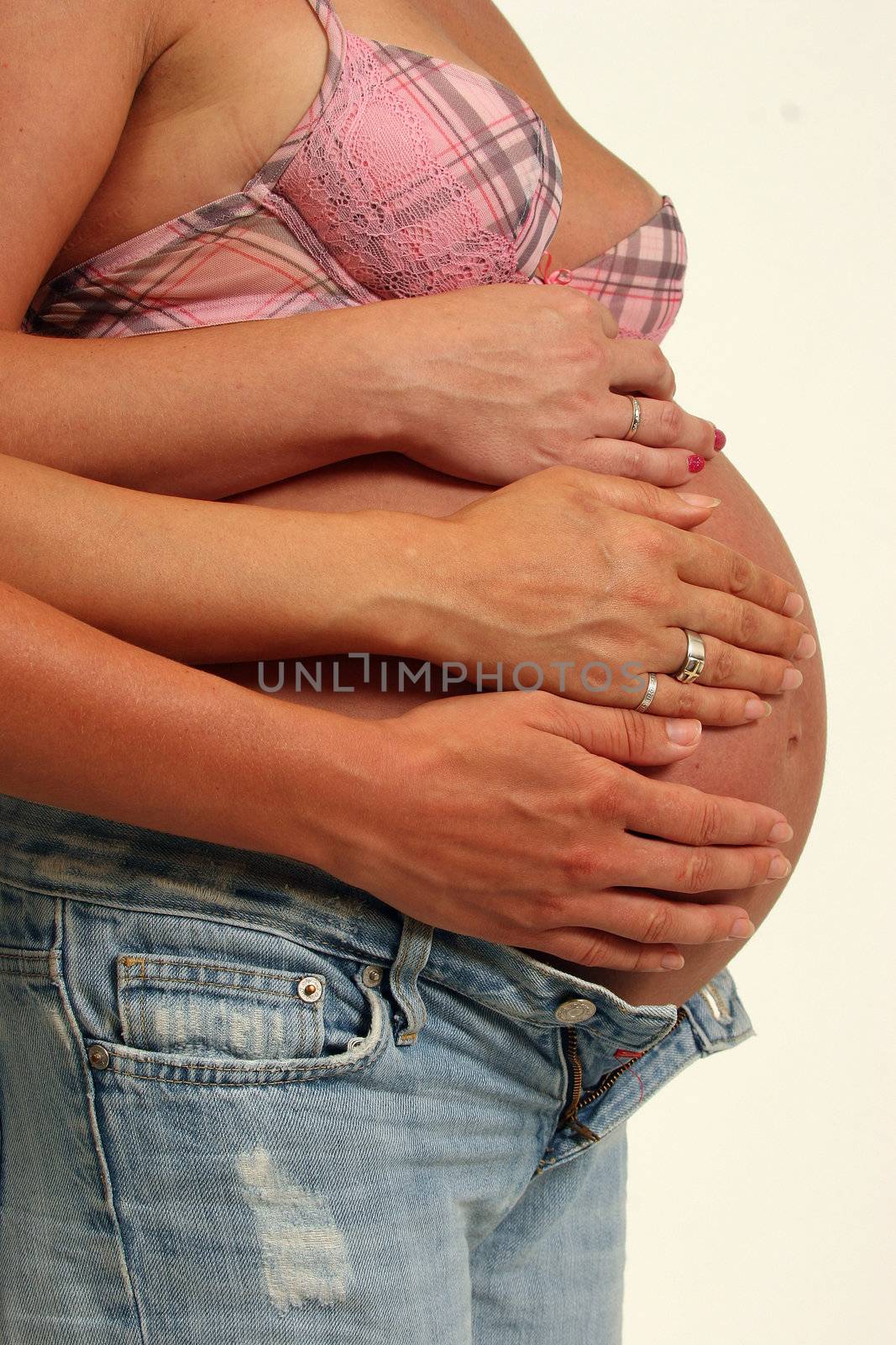 pregnant womens with hands on her belly