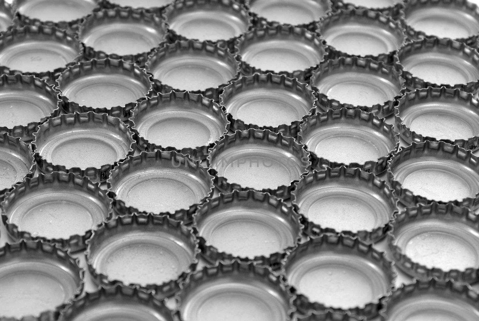 A macro shot of many bottle caps making an abstract background.
