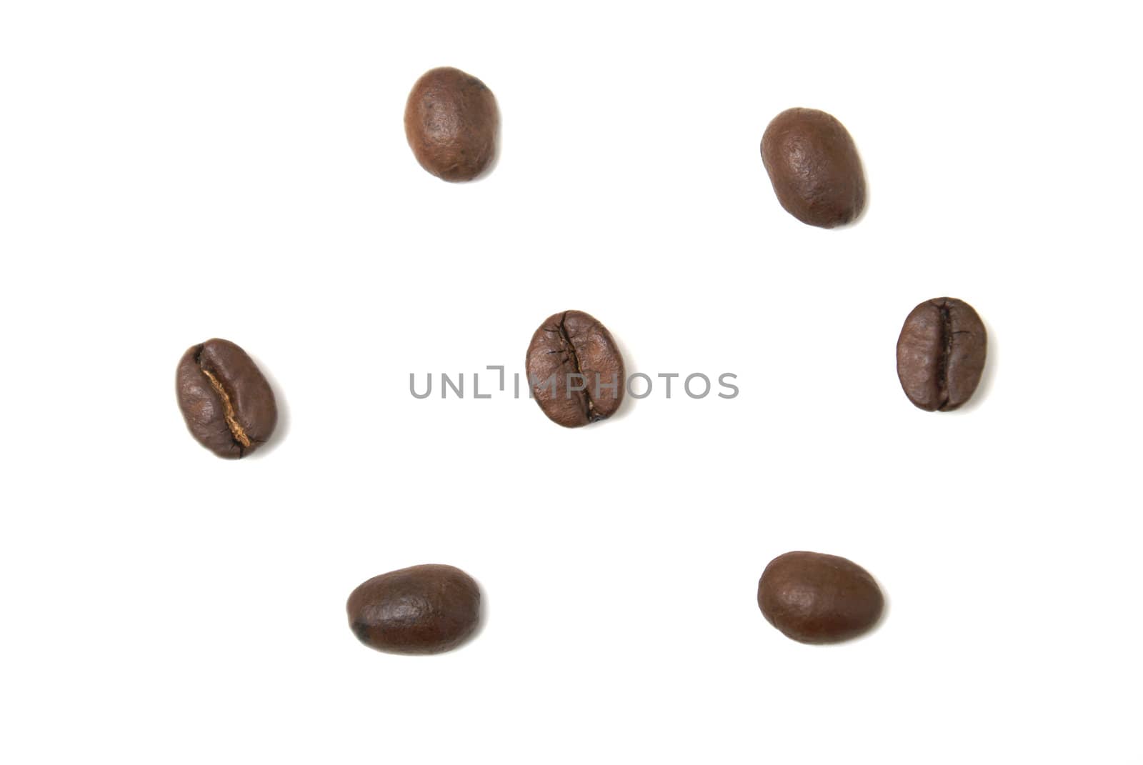 Seven coffee beans isolated on white background.