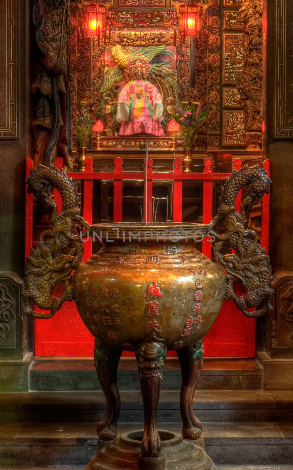 It is an chinese incense burner and god behind.