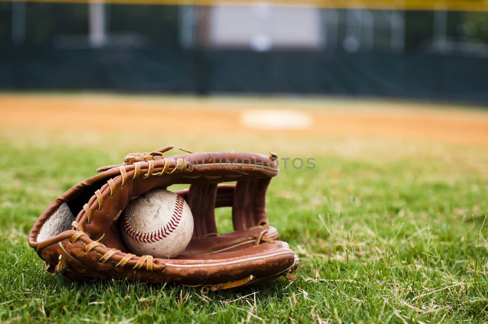 Old Baseball and Glove on Field by dehooks