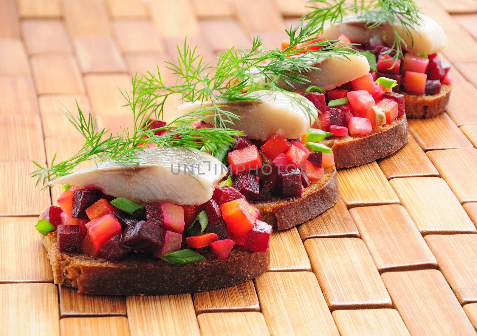 Sandwiches with rye bread, herring and vegetables