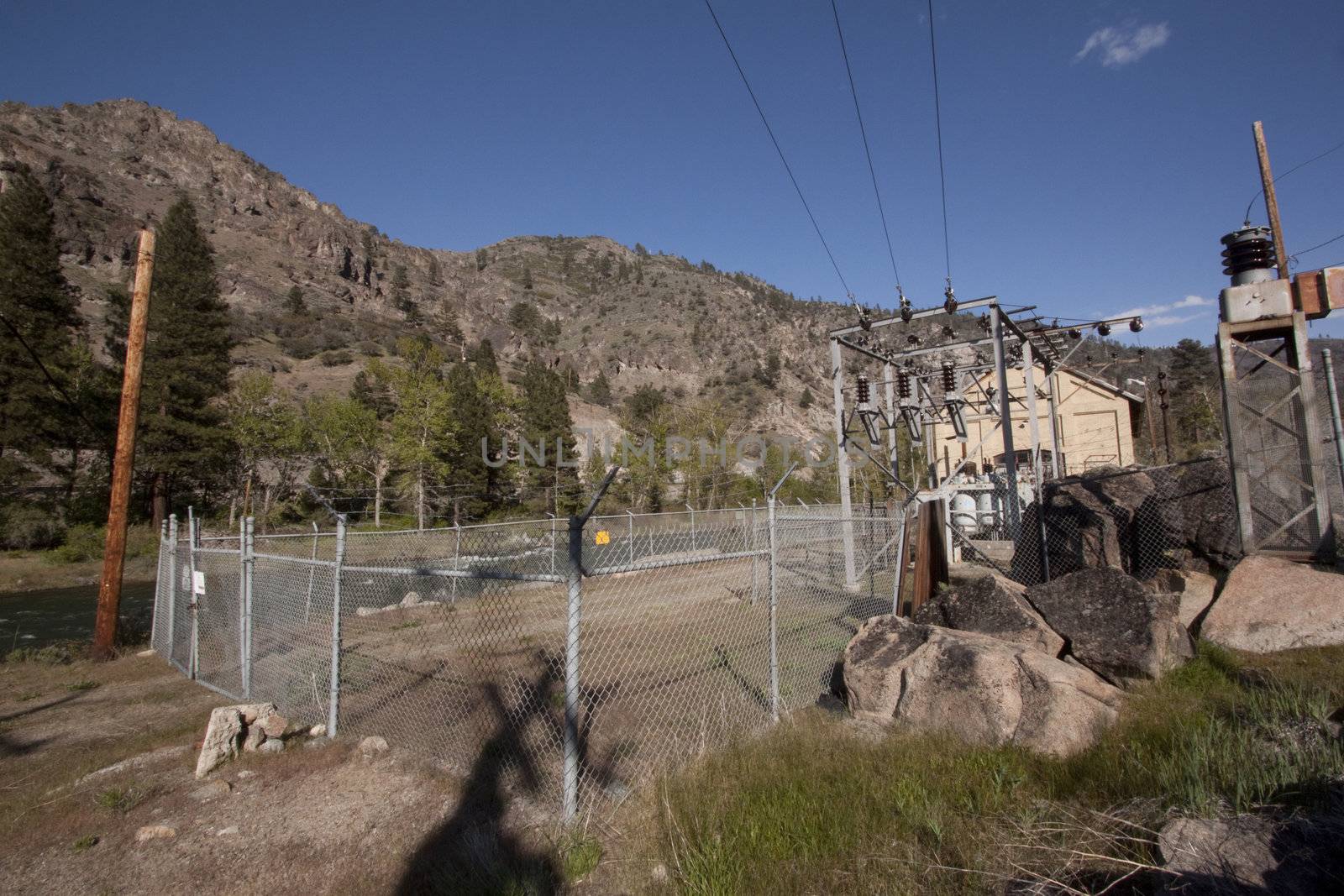 a power plant next to the river in the middle of the forest powe by jeremywhat