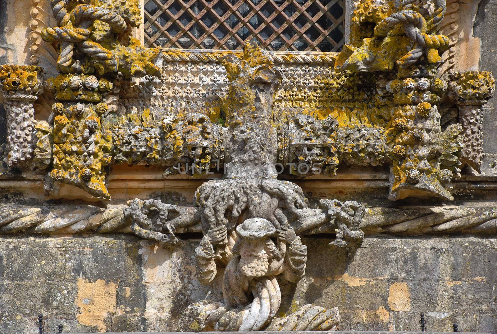 Detail with author face of the most famous window in manuelino-style, Christ Convent cloister, Tomar, Portugal. 