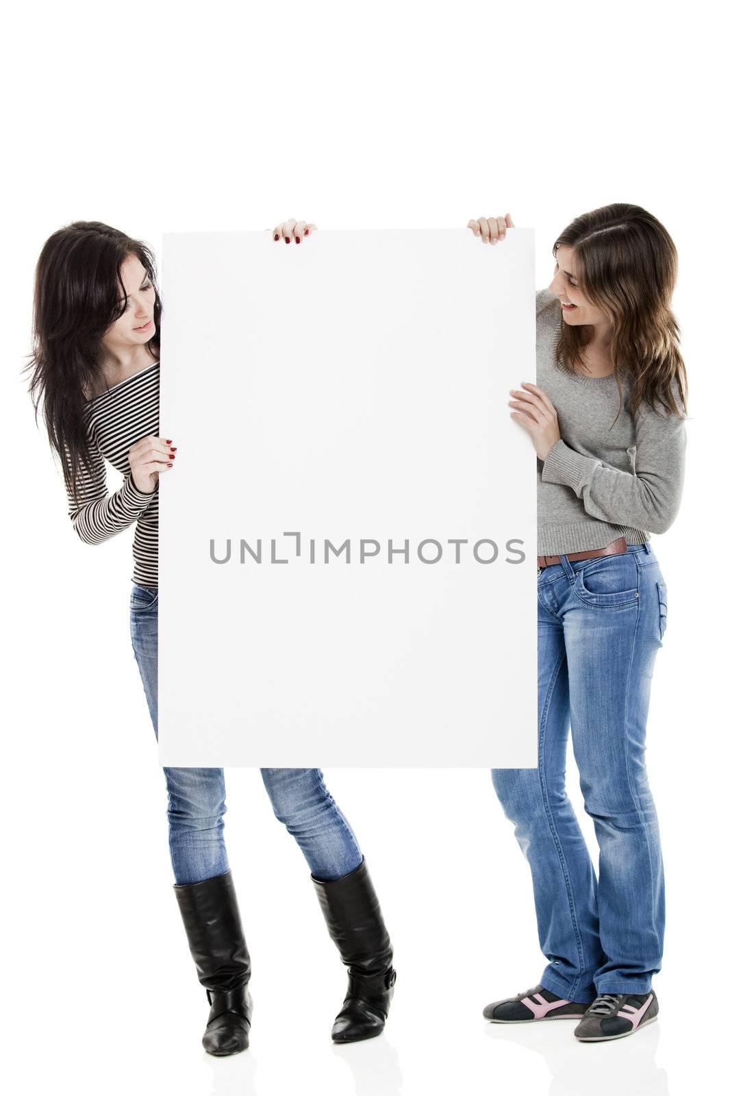 Portrait of two beautiful young women holding a blank notecard.