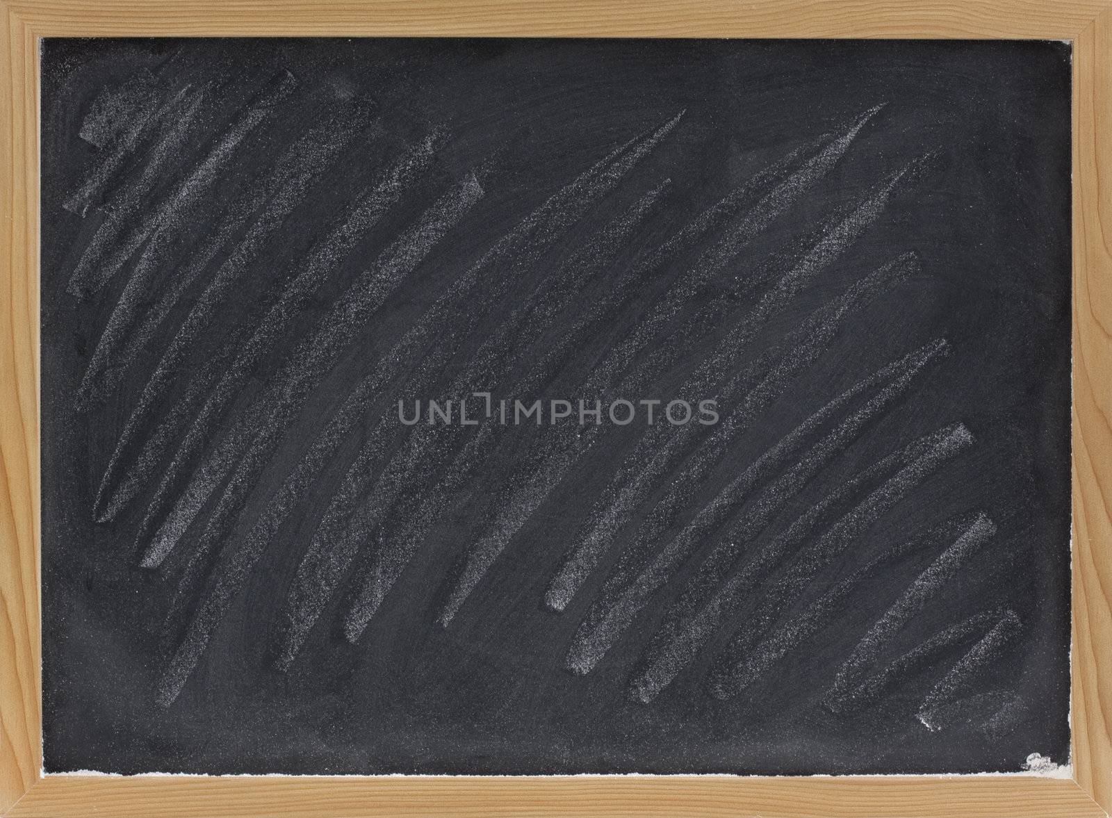 small blank blackboard with with white chalk dust and smudges