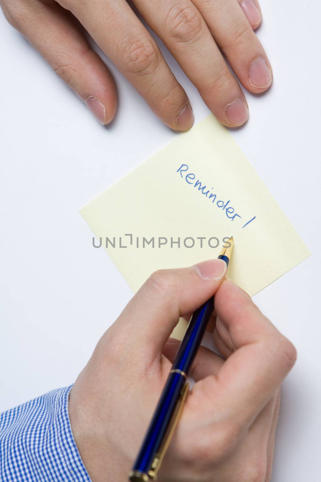 Person writing a message on a piece of paper or note