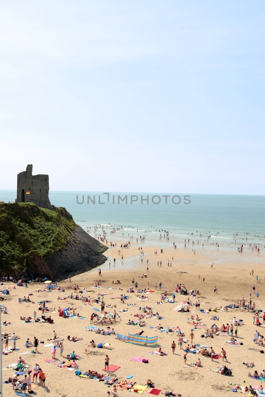 ballybunion beach crowded with people on a hot day with castle