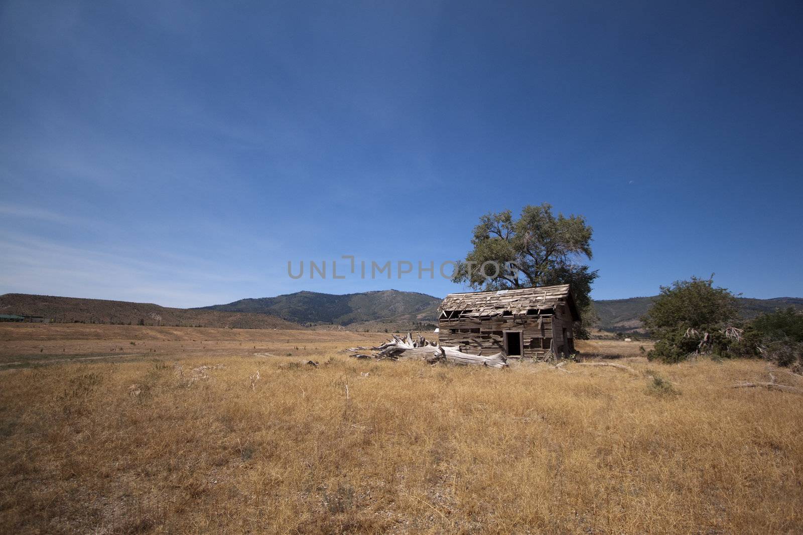 an old abandoned barn in an open field