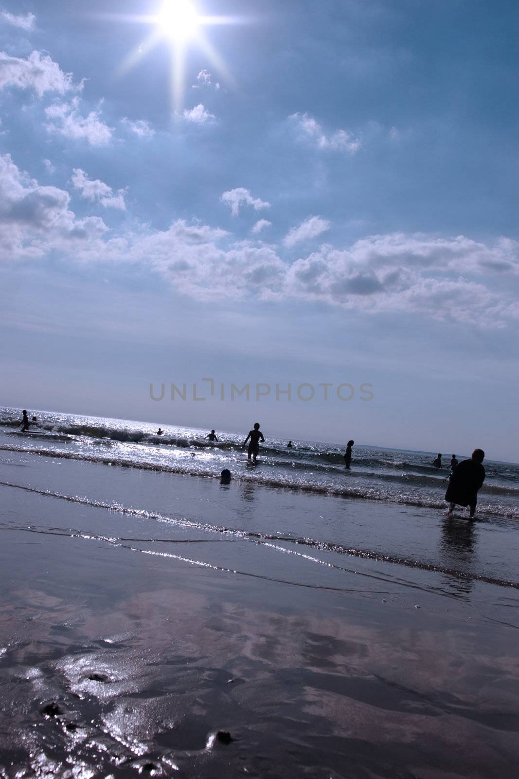 ballybunion beach crowded with people sillhoueted on a hot day