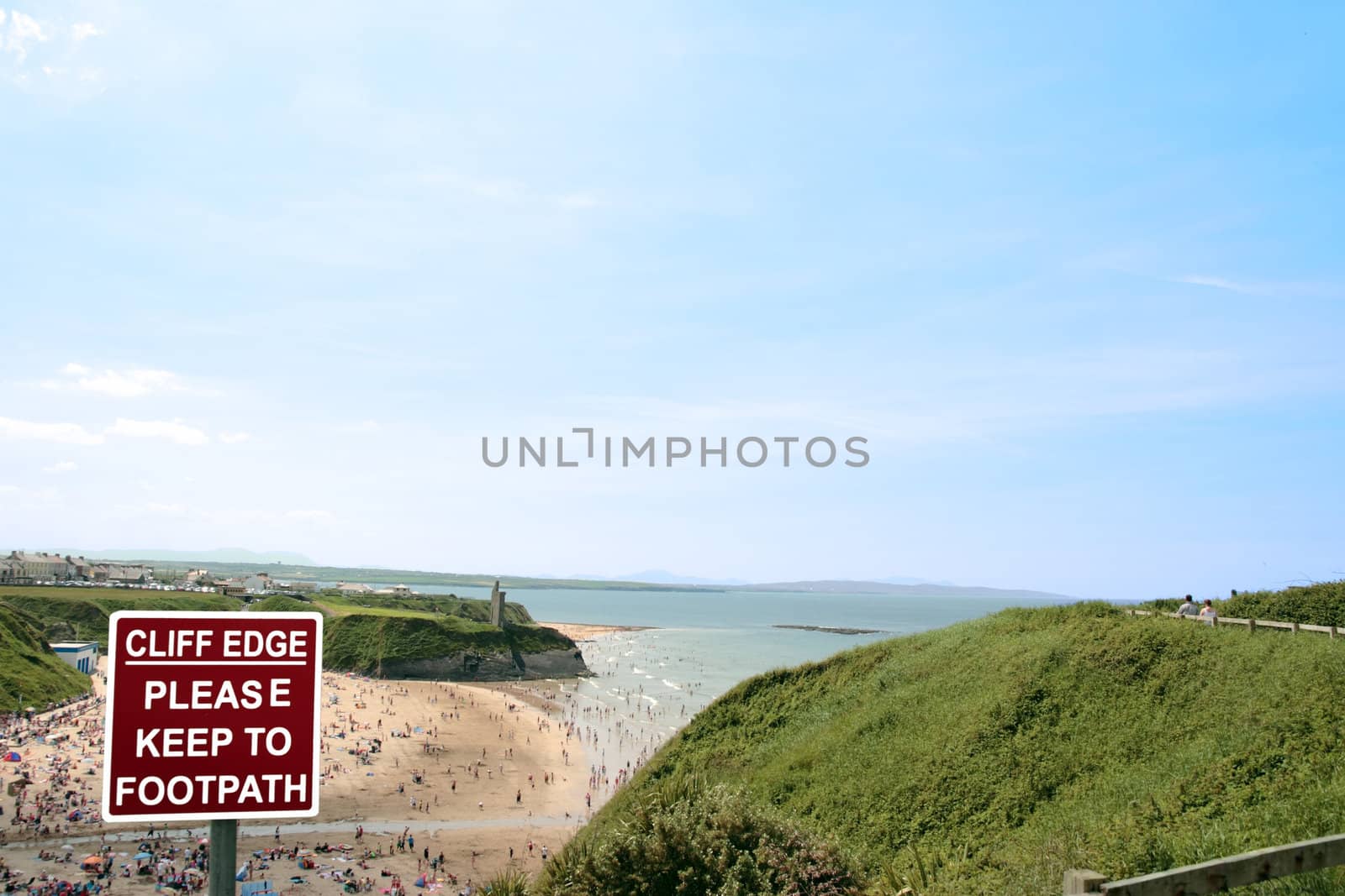 a warning sign on a cliff path walk