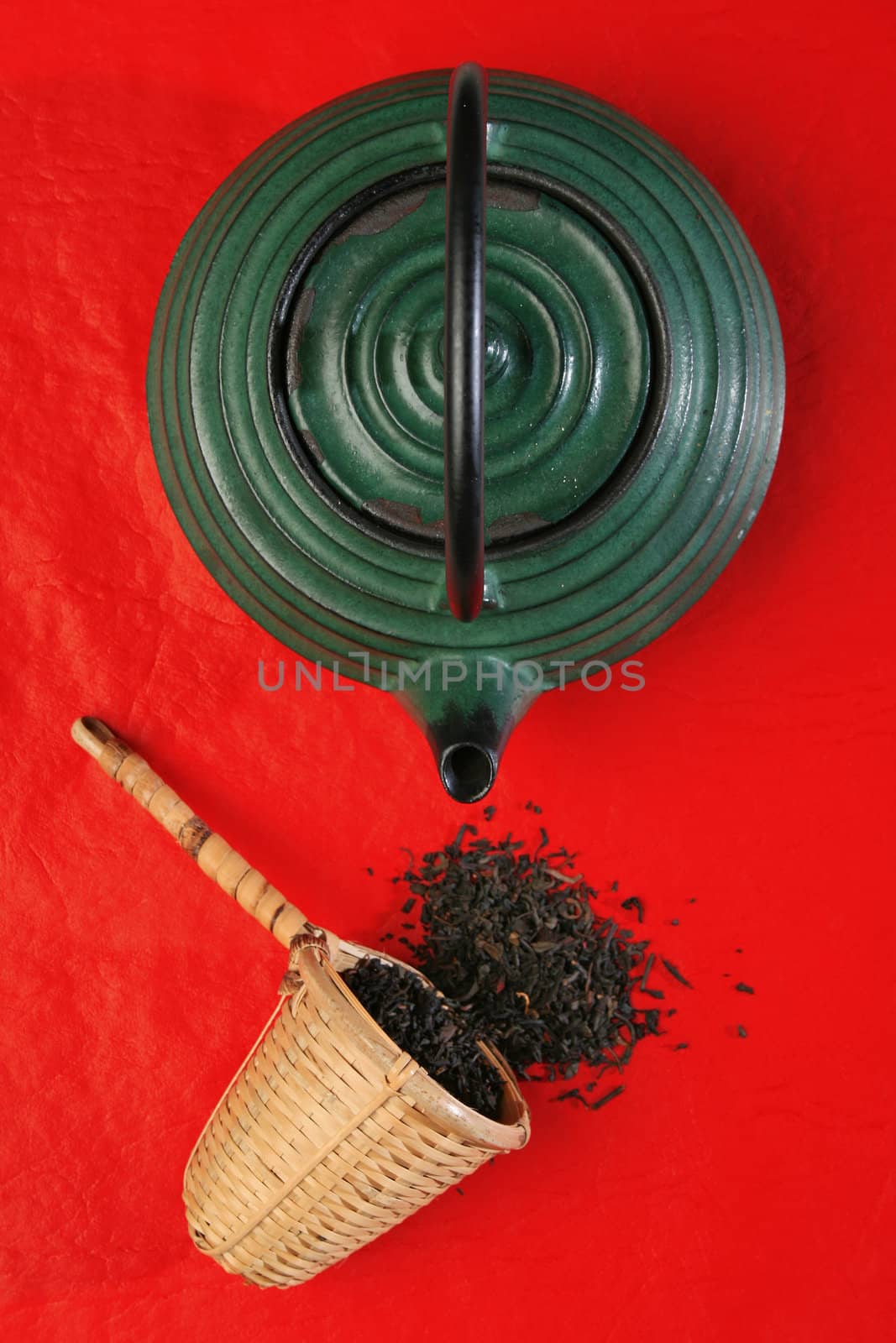 Chinese teapot and a wicker scoop with herb tea leaves. More in gallery