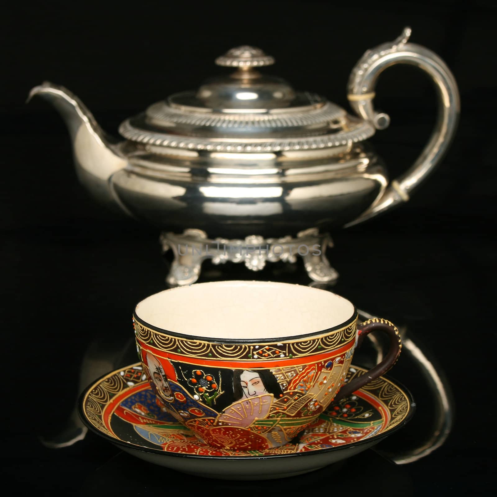 Silver teapot and an antique chinese cup of tea by Erdosain