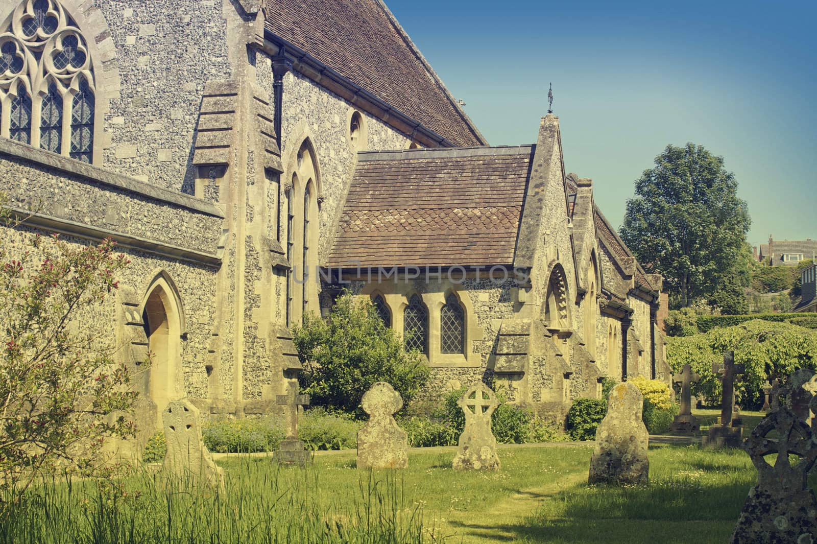 A medieval rural country church. Located in the village of Laverstock, Salisbury, Wiltshire UK. View showing main entrance. A vintage retro effect has been applied to image, evocative of an old postcard.