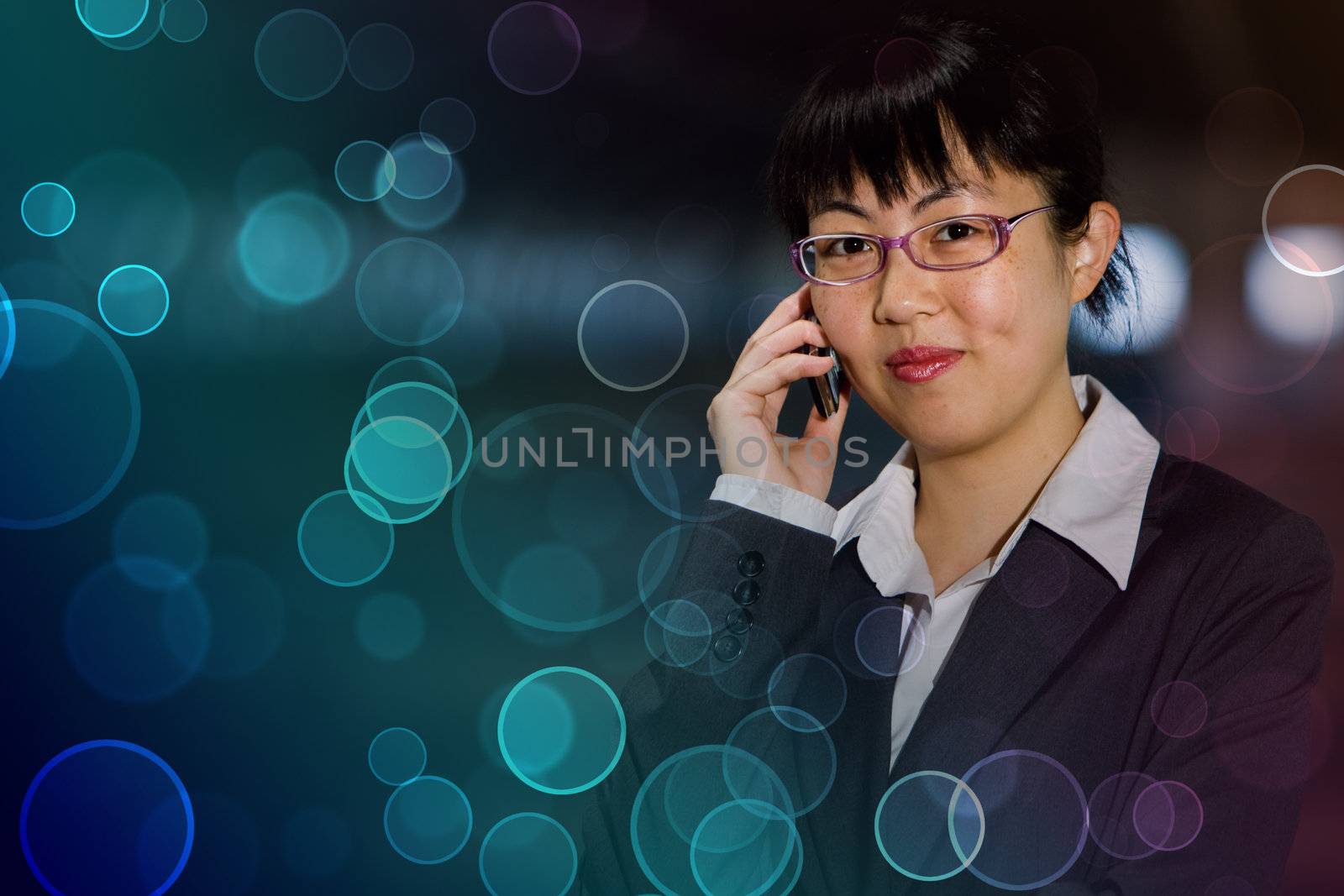 Asian business woman posing with mobile phone against colorful retro circles