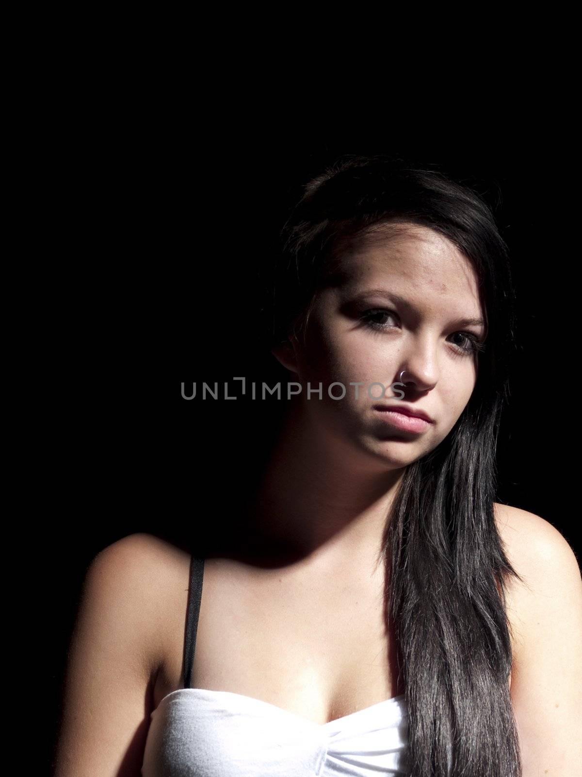 a teen girl portrait with moody lighting