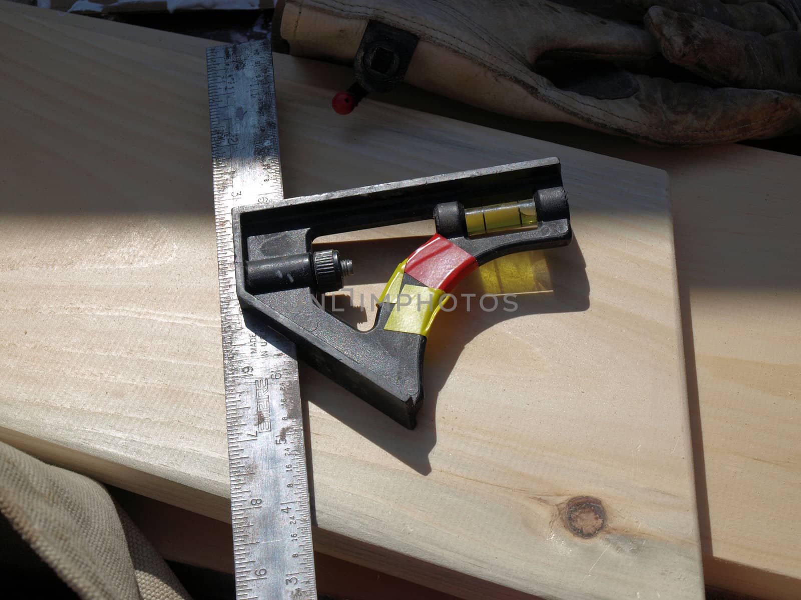 A workman's tool on a piece o wood. 