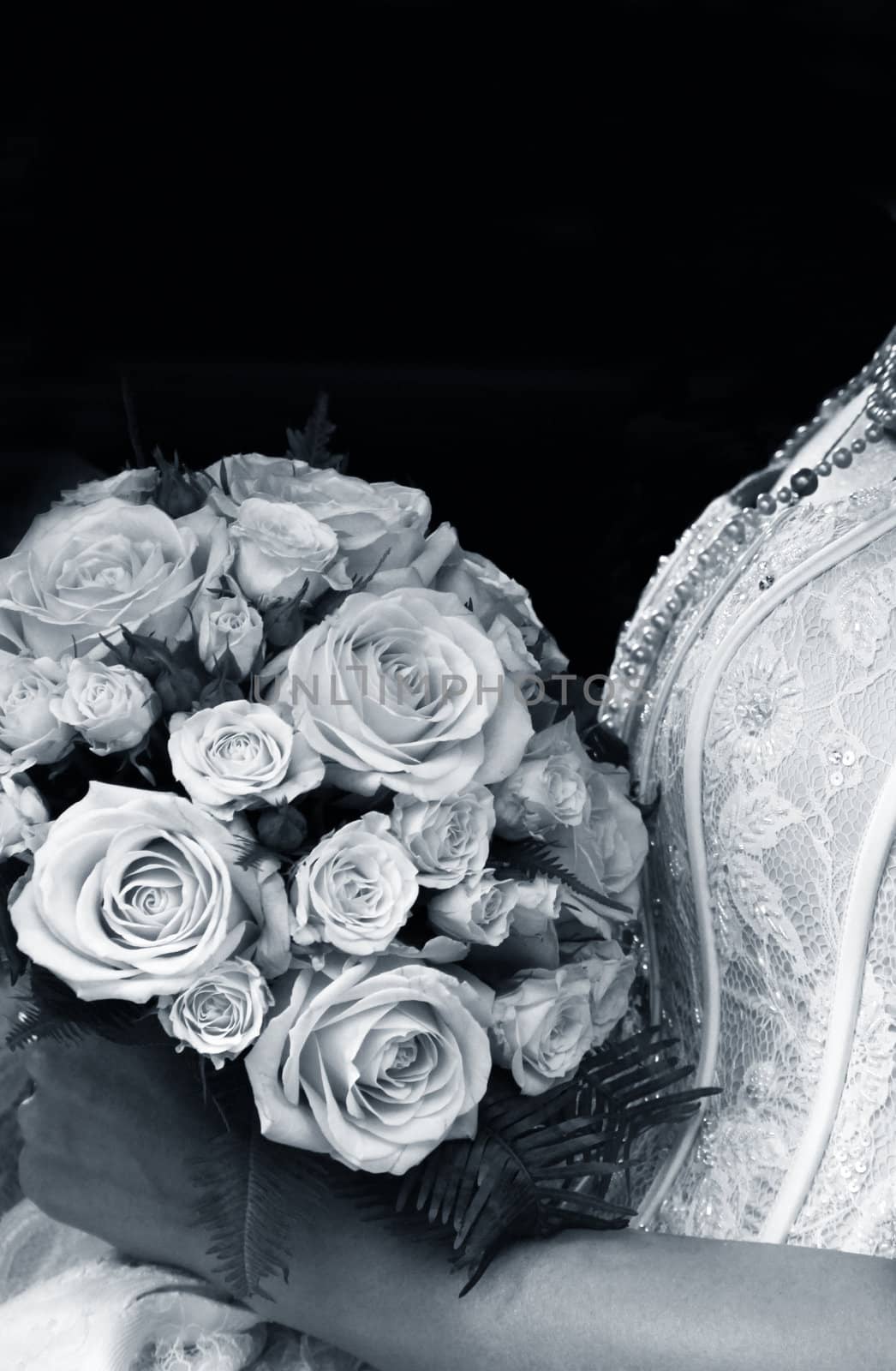 The bride holds a wedding bouquet