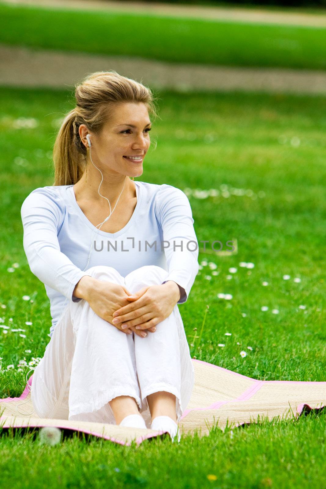 Blonde girl in park relaxing by hfng