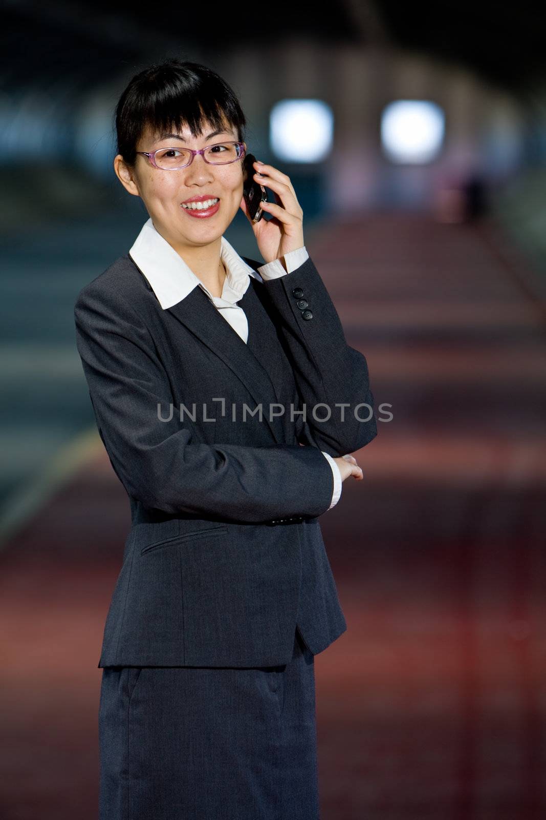 Asian business woman with mobile phone by hfng