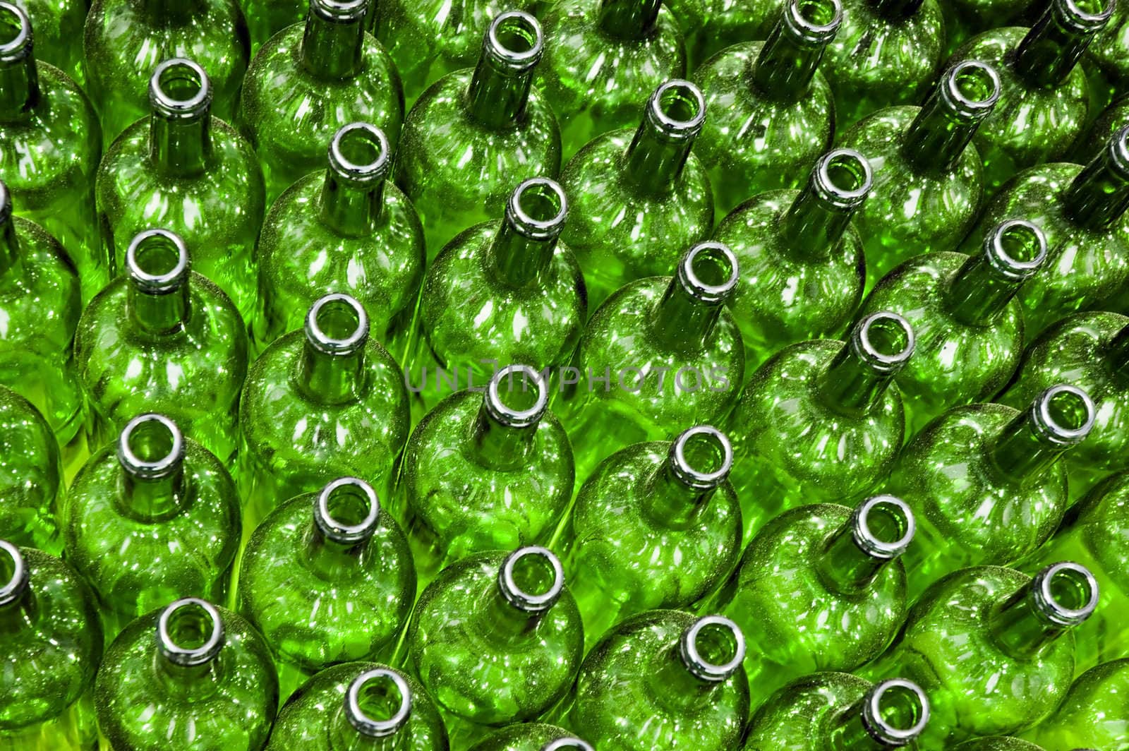 Huge stack of empty green glass bottles