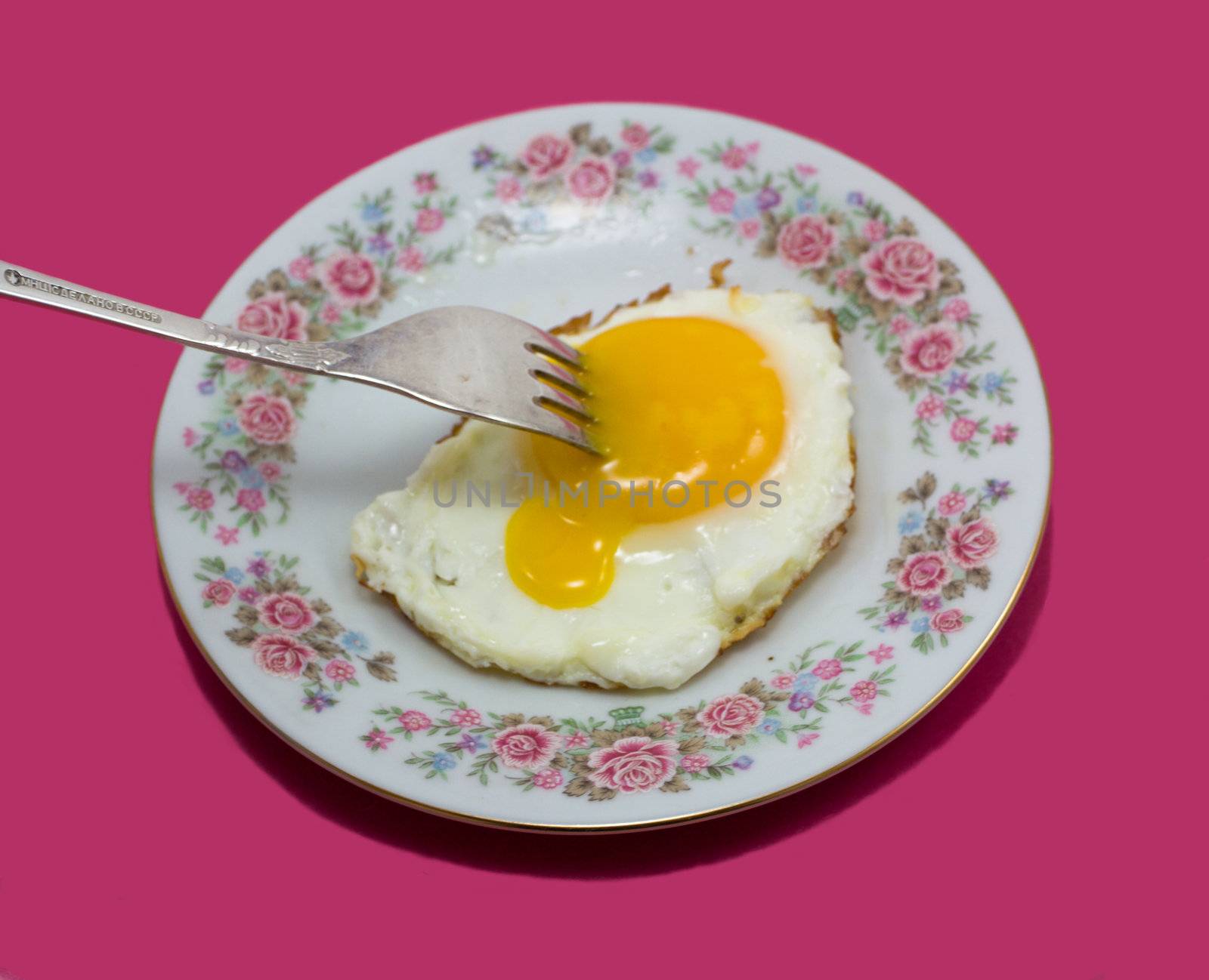 fried egg with fork by Alekcey
