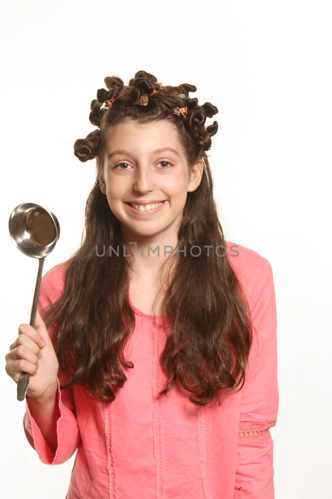 The girl holds in hands ladle and smiles
