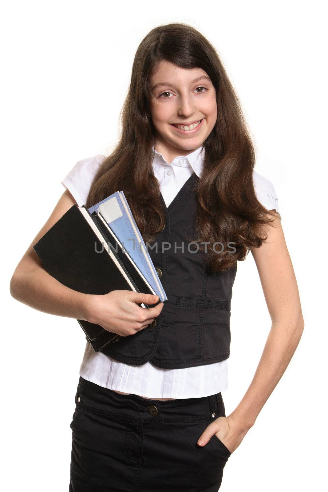 The schoolgirl holds books and looks in a camera
