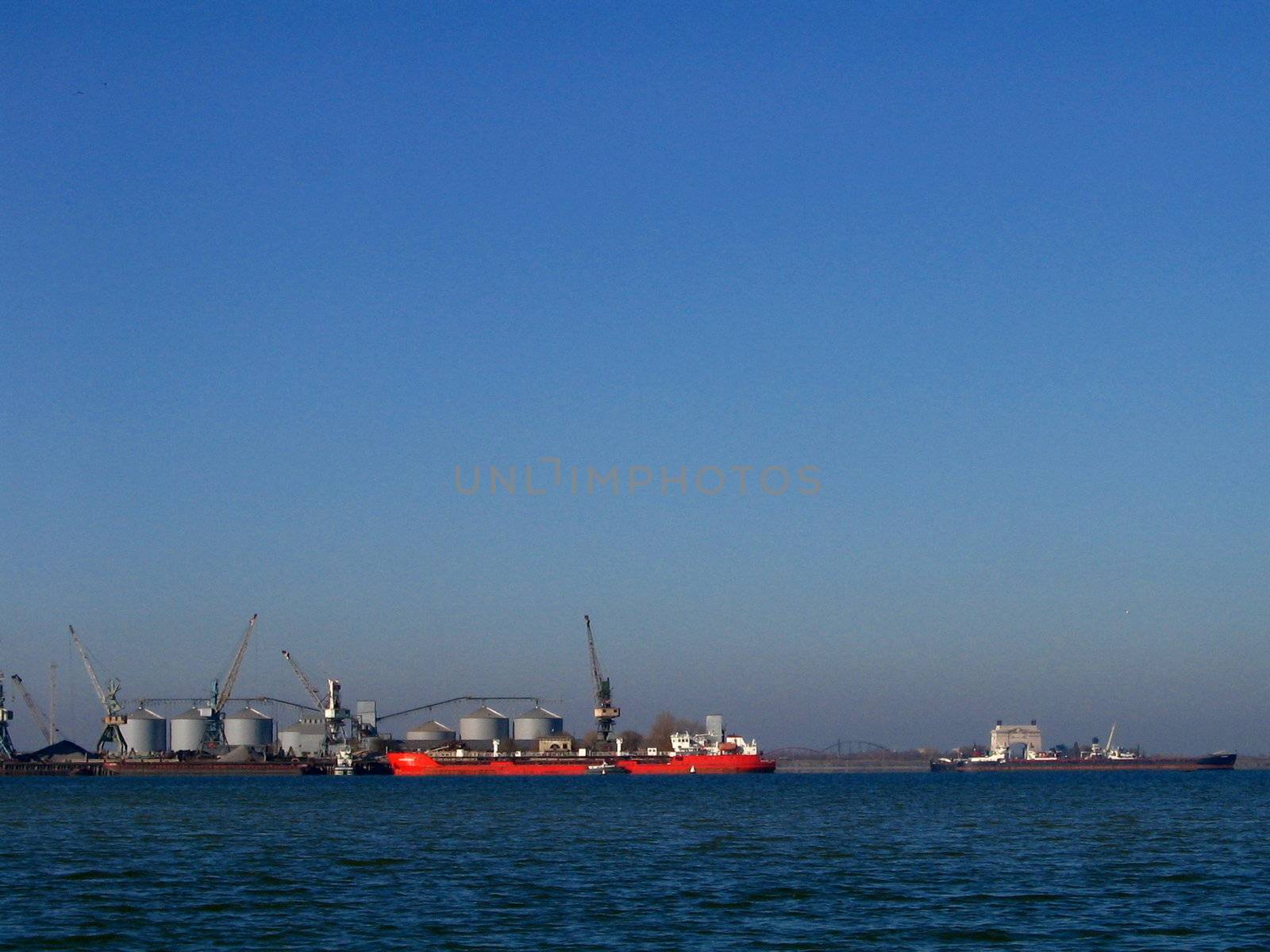 Red oil tanker on seaport