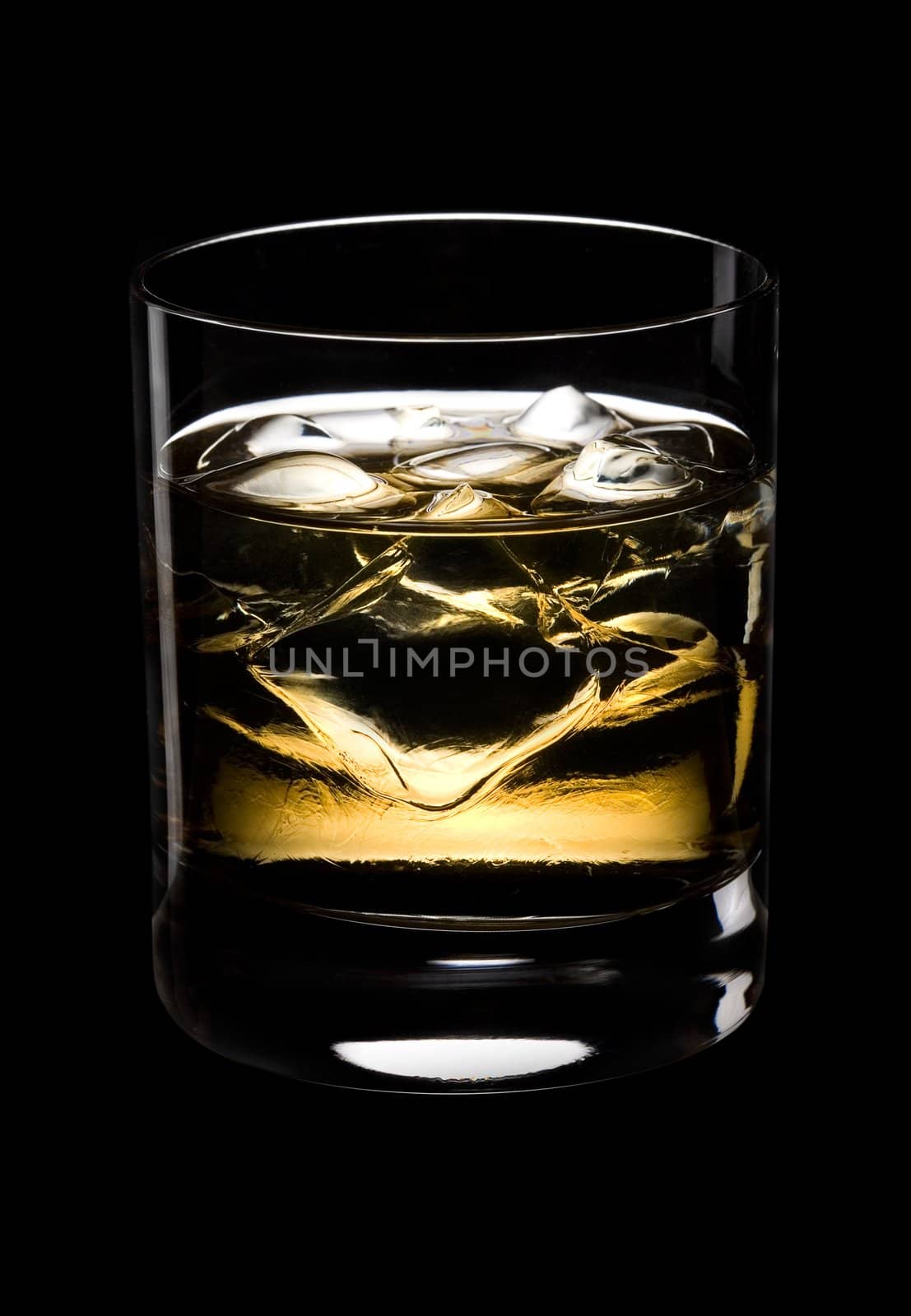 Glass of whisky with ice on a black background 
