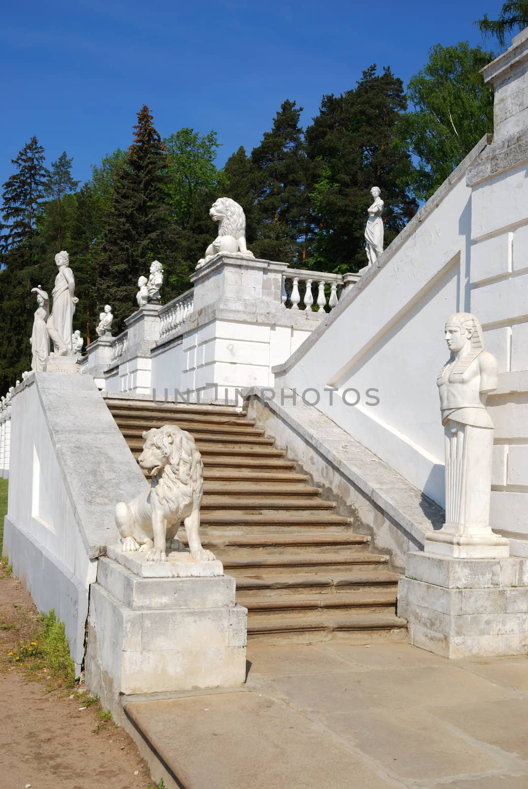Stairs with classical marble statues in terraced garden. Arkhangelskoe estate, Moscow, Russia. Vertical version
