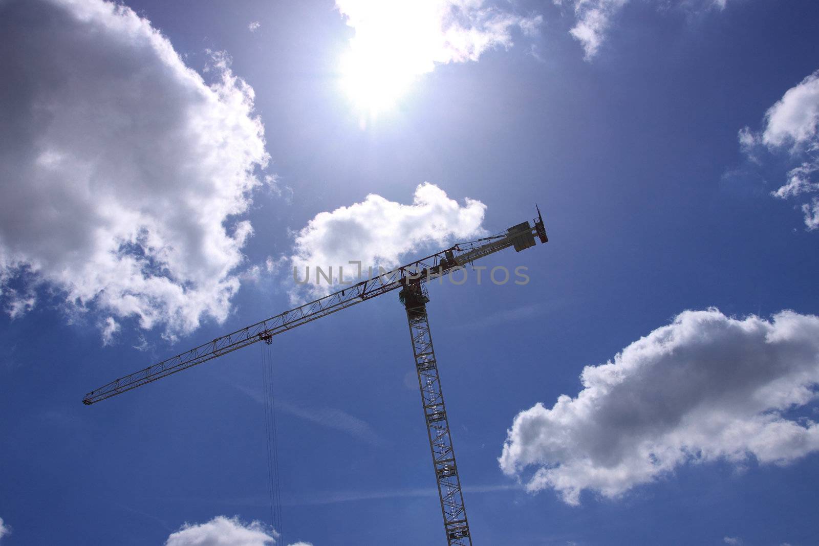 Construction crane against the blue sky 