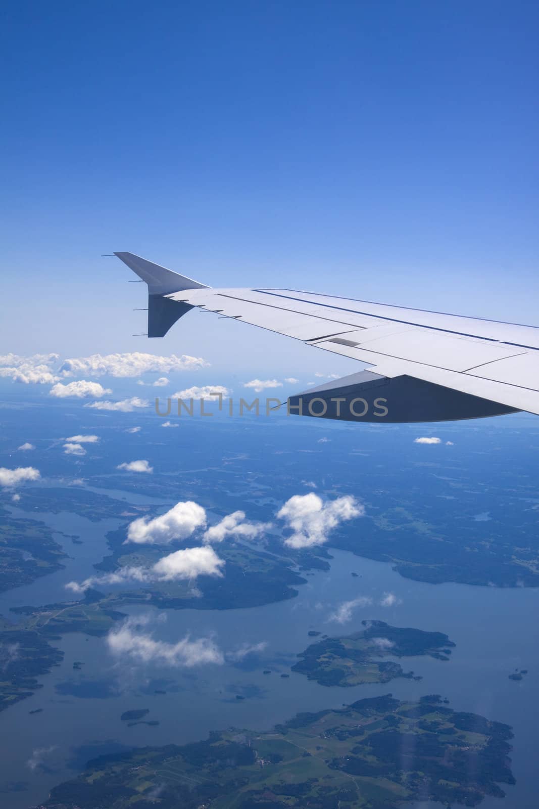 A view of wing and clouds from an airplane window