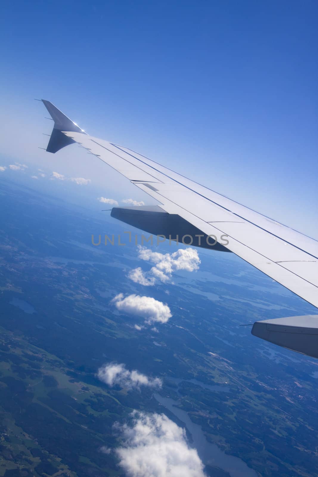 A view of wing and clouds from an airplane window