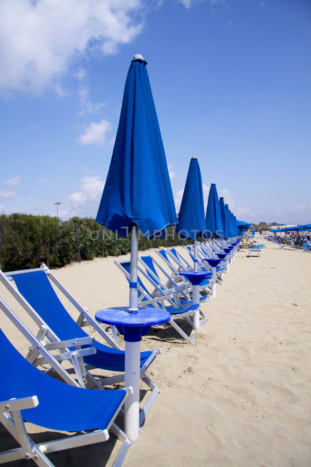 Closed beach umbrellas by kaferphoto