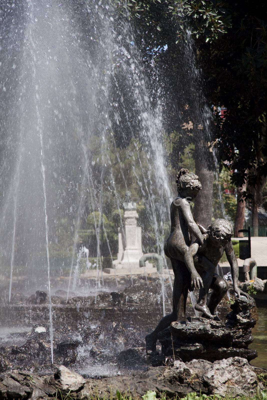 Fountain with a statue of a girl helping a smaller boy in Palermo Sicily Italy