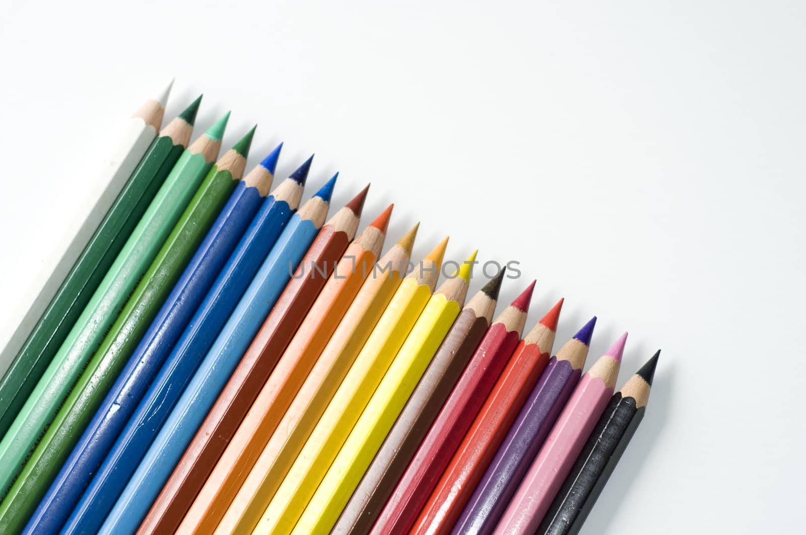 Colored pencils on white background. Sharpened rods. Colorful.