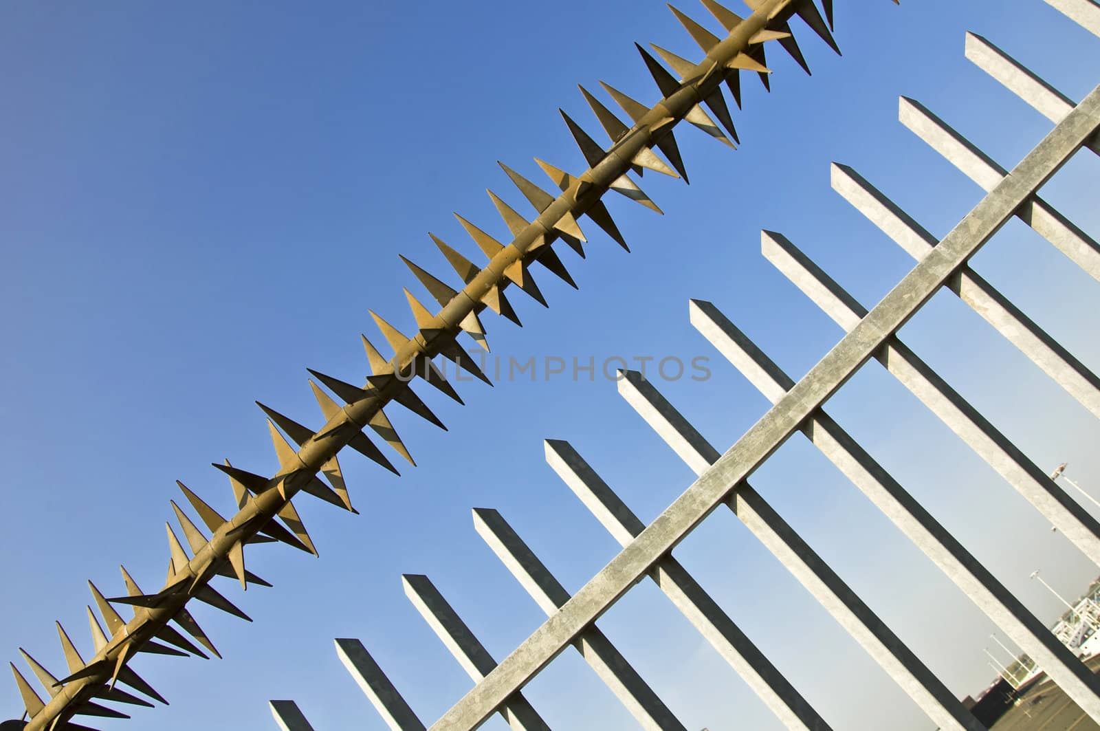 Barbed wire fence at the blue sky. metaphor of freedom and incarceration