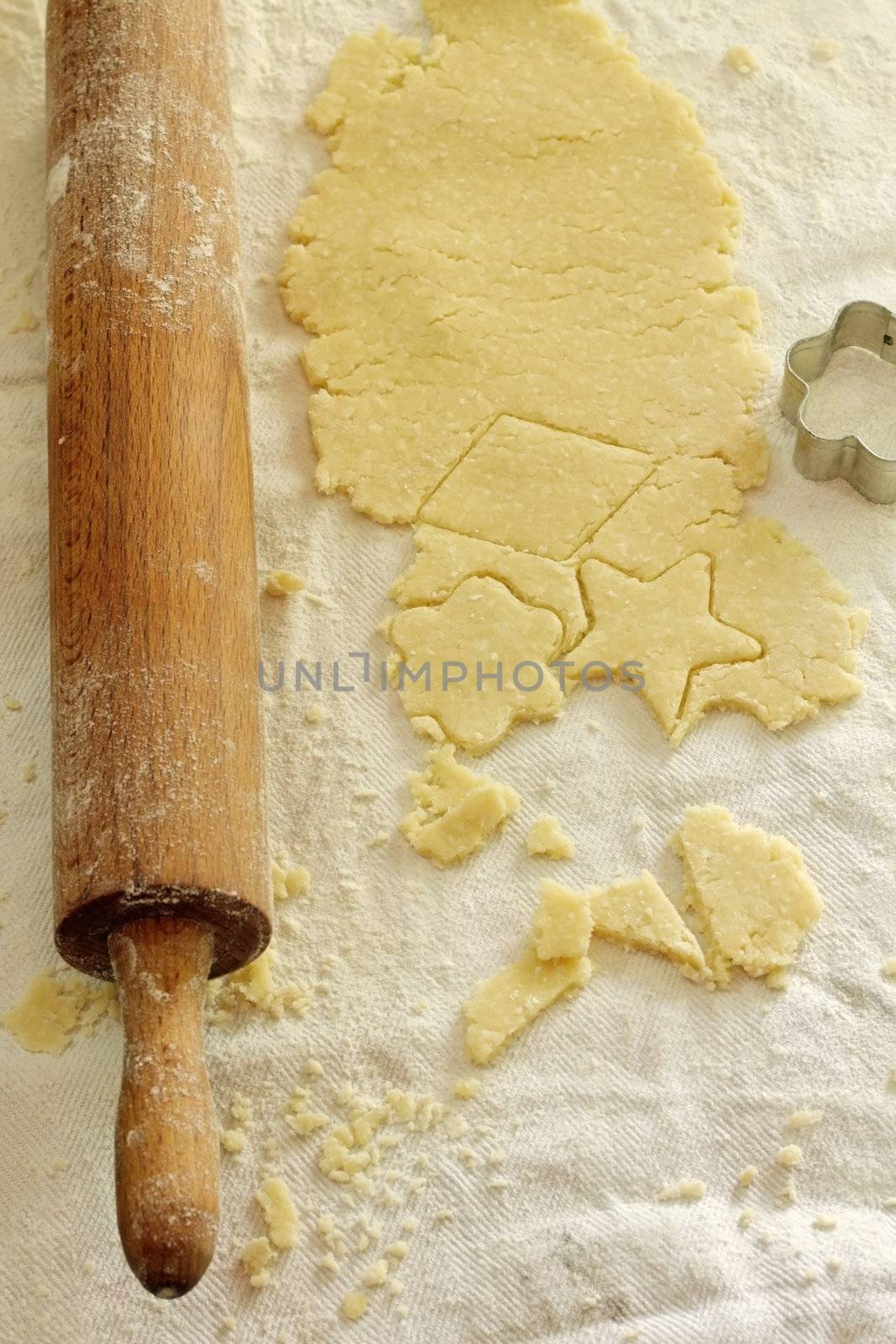 shaped cut dough and rolling pin on the table 