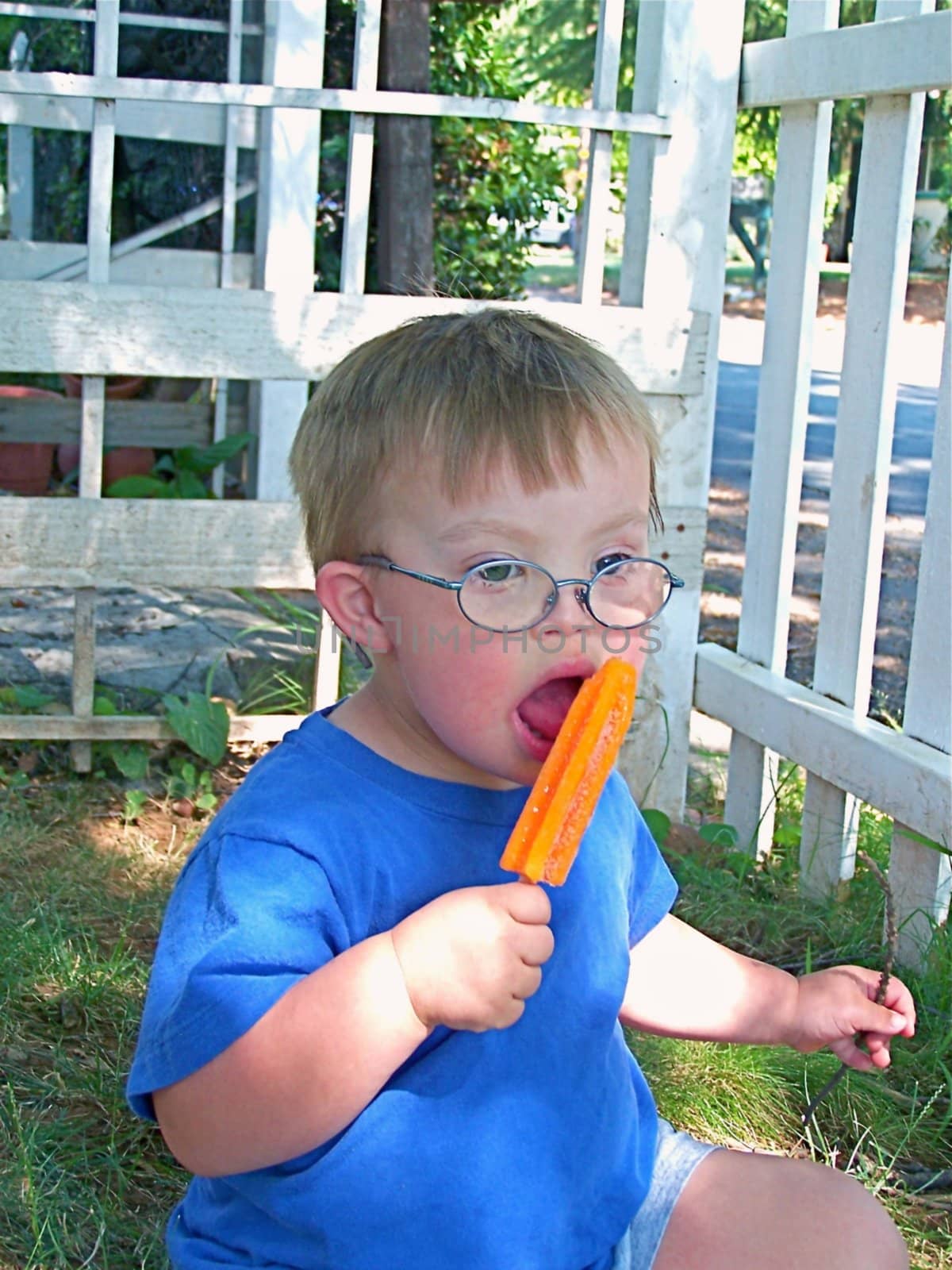 Boy with Downs Syndrome eating a popsicle